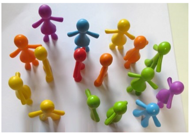 Sixteen vibrant plastic figurines arranged in groups of four on a clean white background.
