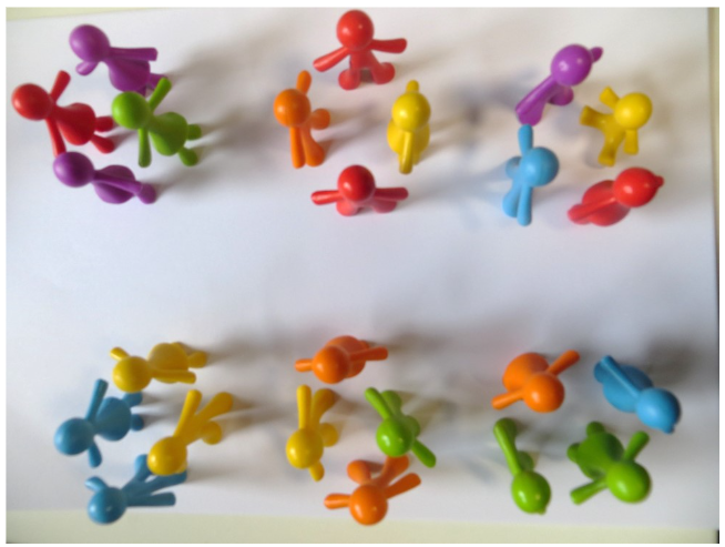Six groups of vibrant plastic figurines arranged in groups of four on a clean white background.
