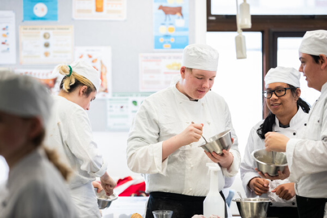 Group of students working together in a kitchen.