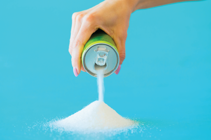 Sugar pouring out of a canned drink.