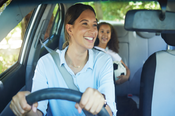 A mum driving her kid to school.