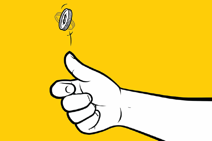 A hand tossing a coin into the air.