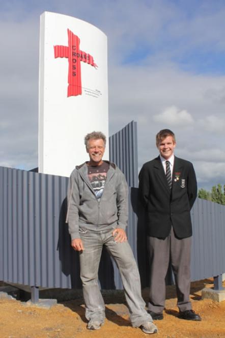 Student Trent Summers and his father, Tim, standing in front of his church sign.