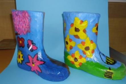 Papier-mâché gumboots created by students.