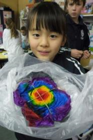 A student showing her t-shirt that she had tied and dyed.