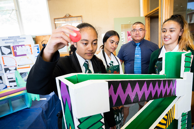 Students partake in a science experiment with their teacher.