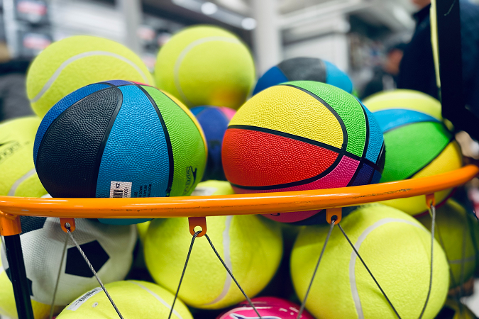 Various balls stacked in a ball crate.