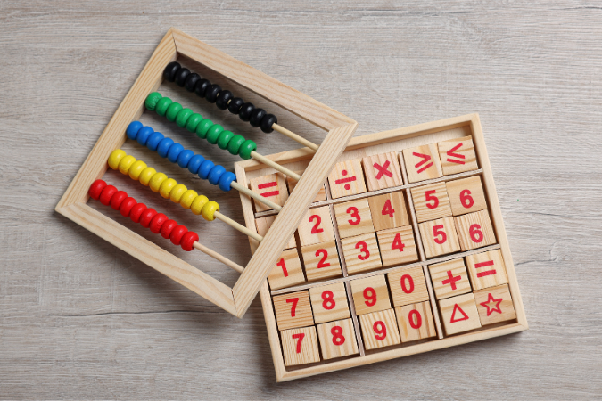 An abacus and a set of wooden number blocks. 