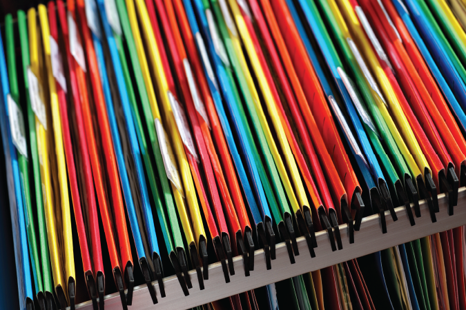 Multicoloured folders in a pull-out drawer. 