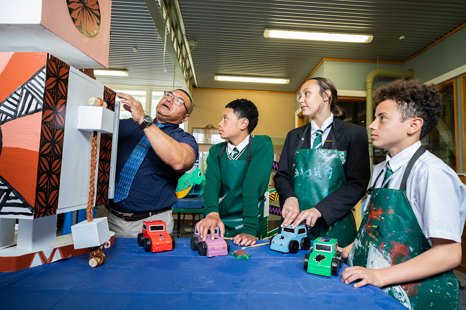 Teacher leading students in the technology classroom.
