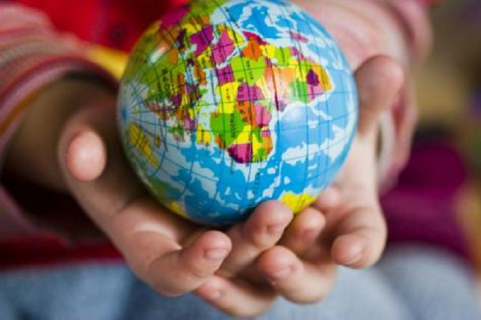 A globe in a child's hands.