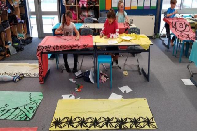 Students’ painting designs on lavalava in class.