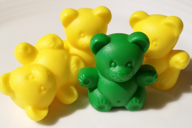 Four plastic bears, one green and three yellow.
