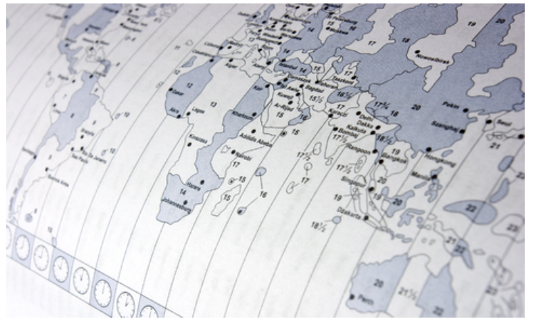 A paper map with the different time zones shown.