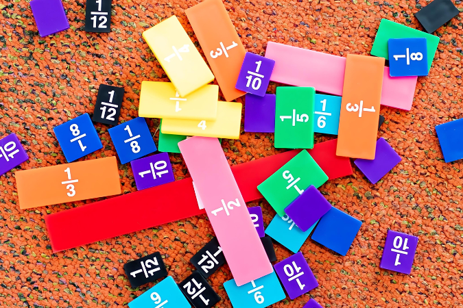 Colourful fraction tiles scattered on the floor.