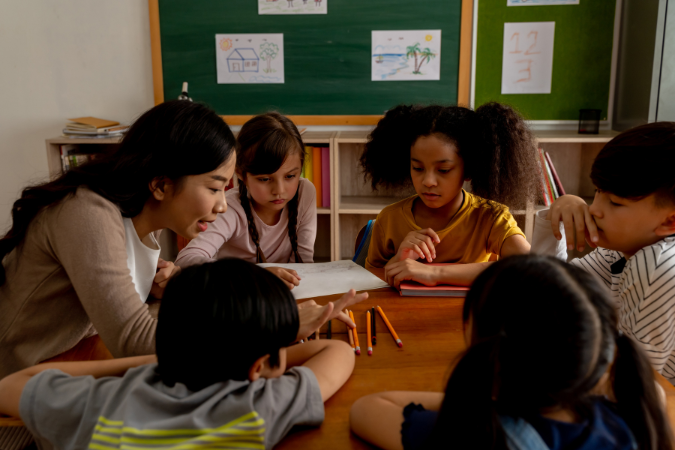 A teacher instructing students in a lesson.