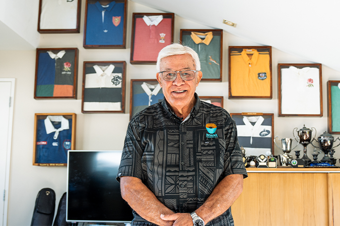 Image showing Pasifika rugby legend Sir Bryan Williams in front of his awards and old rugby jerseys