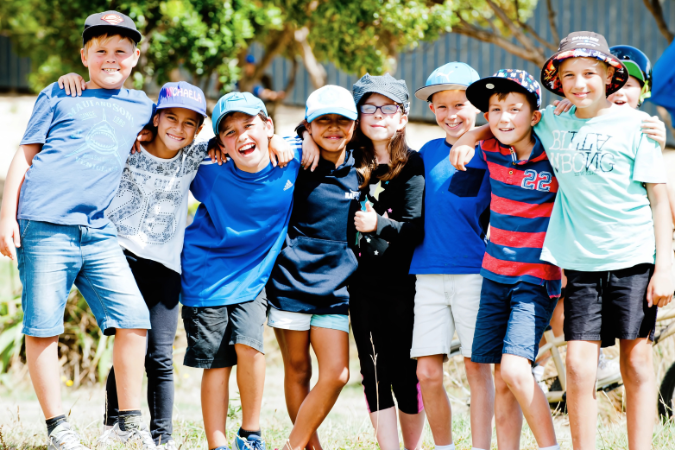 A group of students standing and smiling at the camera.